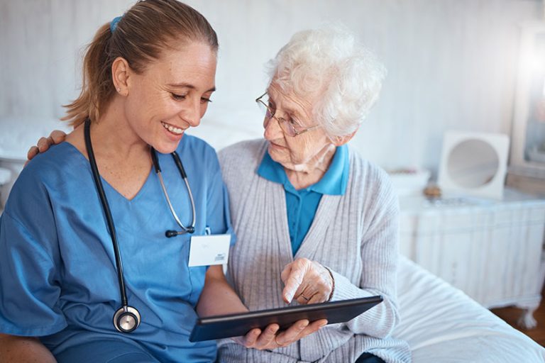 tablet nurse doctor consulting old woman nursing home bedroom blood