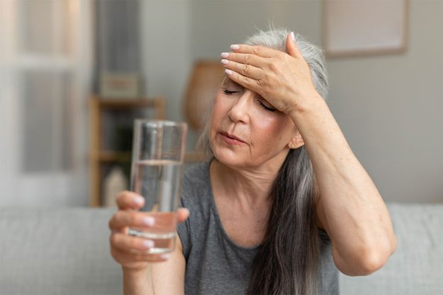 unhappy sad caucasian old lady hold glass water touching forehead unhappy sad caucasian old lady hold glass water touching forehead