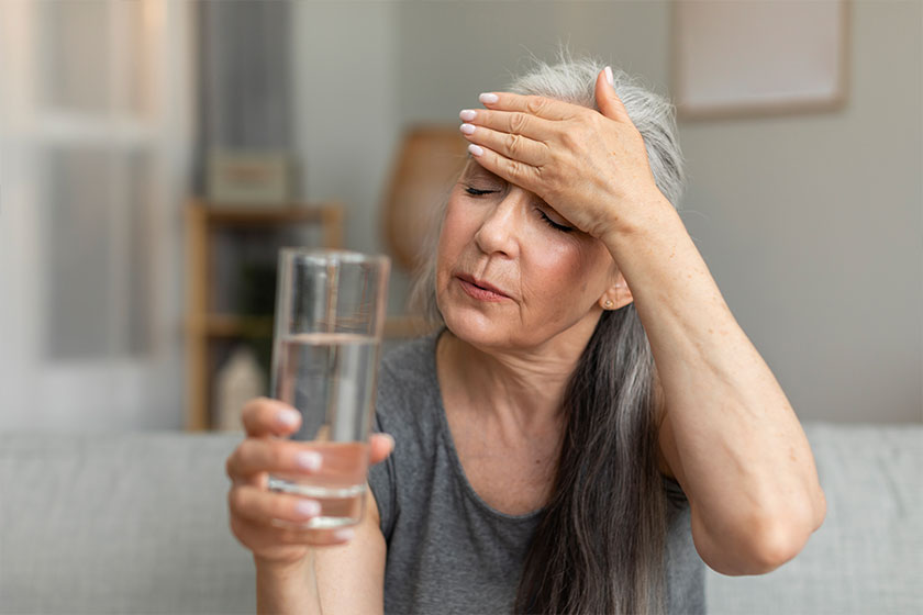 unhappy sad caucasian old lady hold glass water touching forehead unhappy sad caucasian old lady hold glass water touching forehead