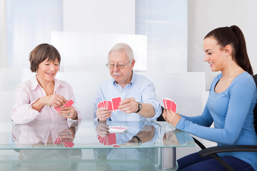 Caretaker Playing Cards With Senior Couple — Photo