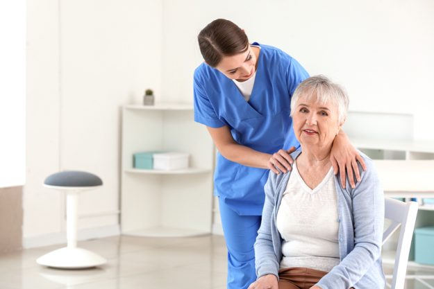 Female doctor with senior woman suffering from Parkinson syndrome in clinic Female doctor with senior woman suffering from Parkinson syndrome in clinic