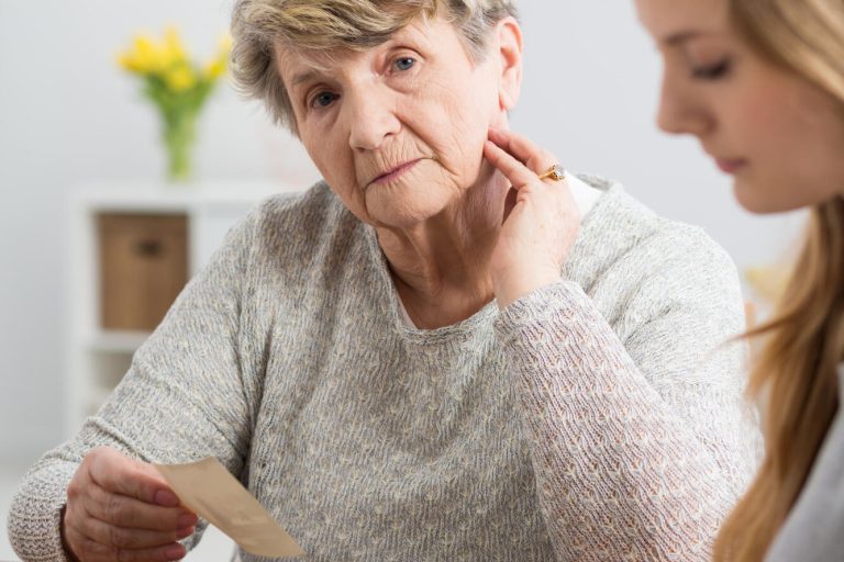 Portrait,Of,An,Upset,Senior,Lady,Watching,Old,Photographs,With