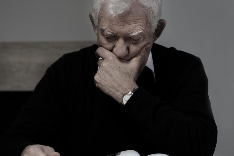 Old,Man,Looking,At,Family,Photo,Album