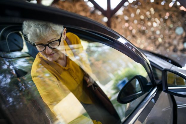 Senior,Woman,With,Glasses,Getting,Out,Of,A,Car.,Shot
