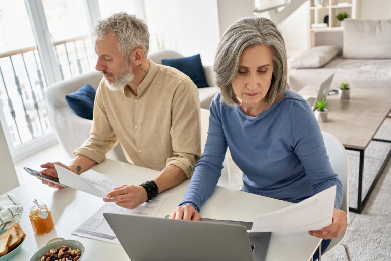 Serious,Mature,Senior,Old,Couple,Reading,Documents,Bills,Paying,Bank