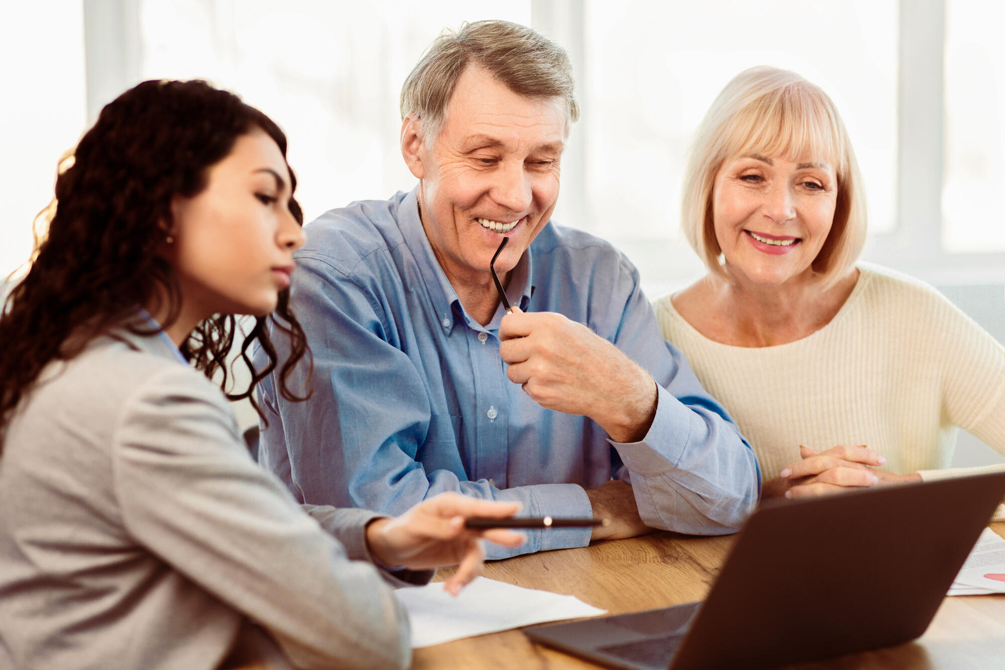 Beautiful female travel agent is working with clients