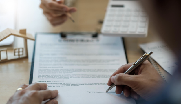 Close up man signing contract