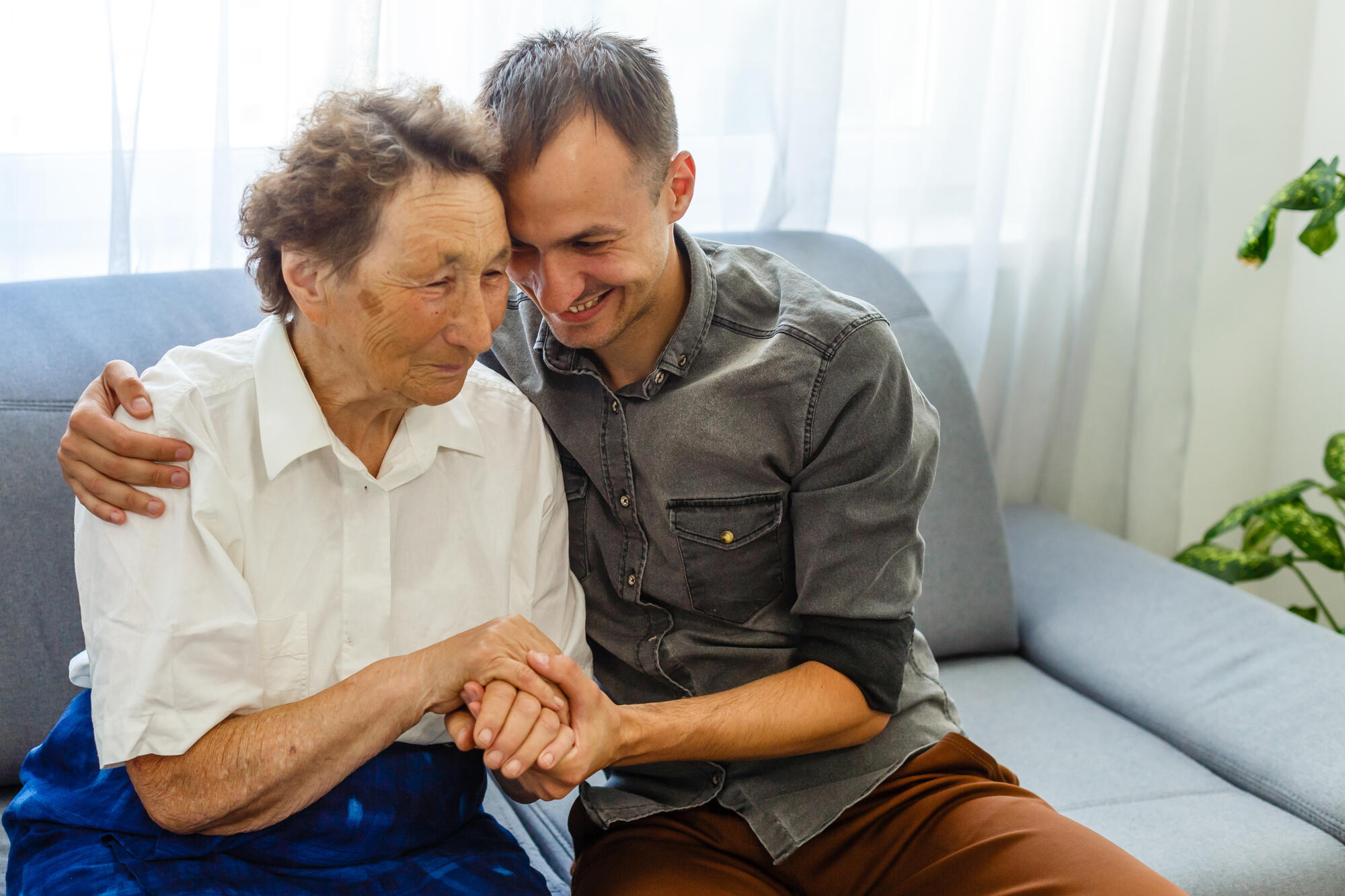Grandson visiting grandmother at home in quarantine