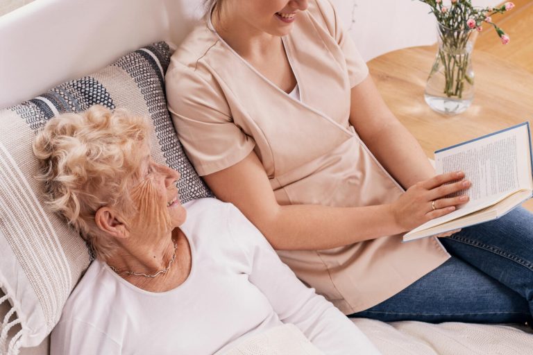 Helpful,Female,Volunteer,Reads,A,Book,To,An,Elderly,Woman