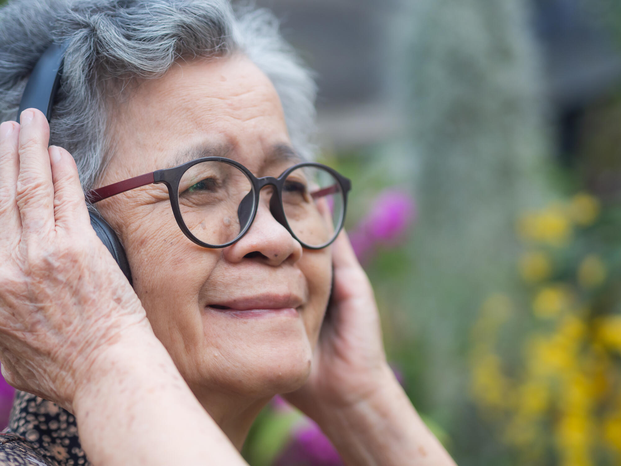 Cheerful senior woman with short gray hair, wearing glasses, smi Cheerful senior woman with short gray hair, wearing glasses, smi
