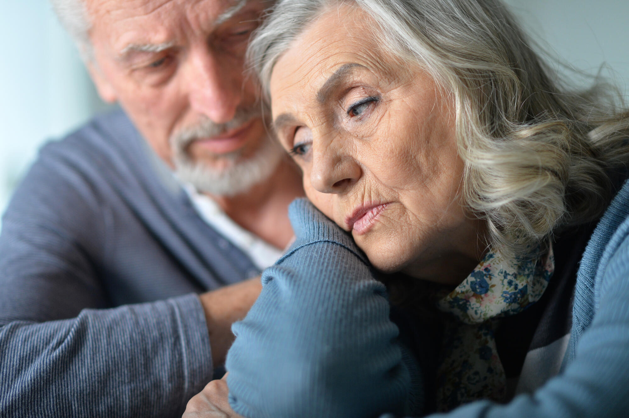Close up portrait of sad senior couple posing