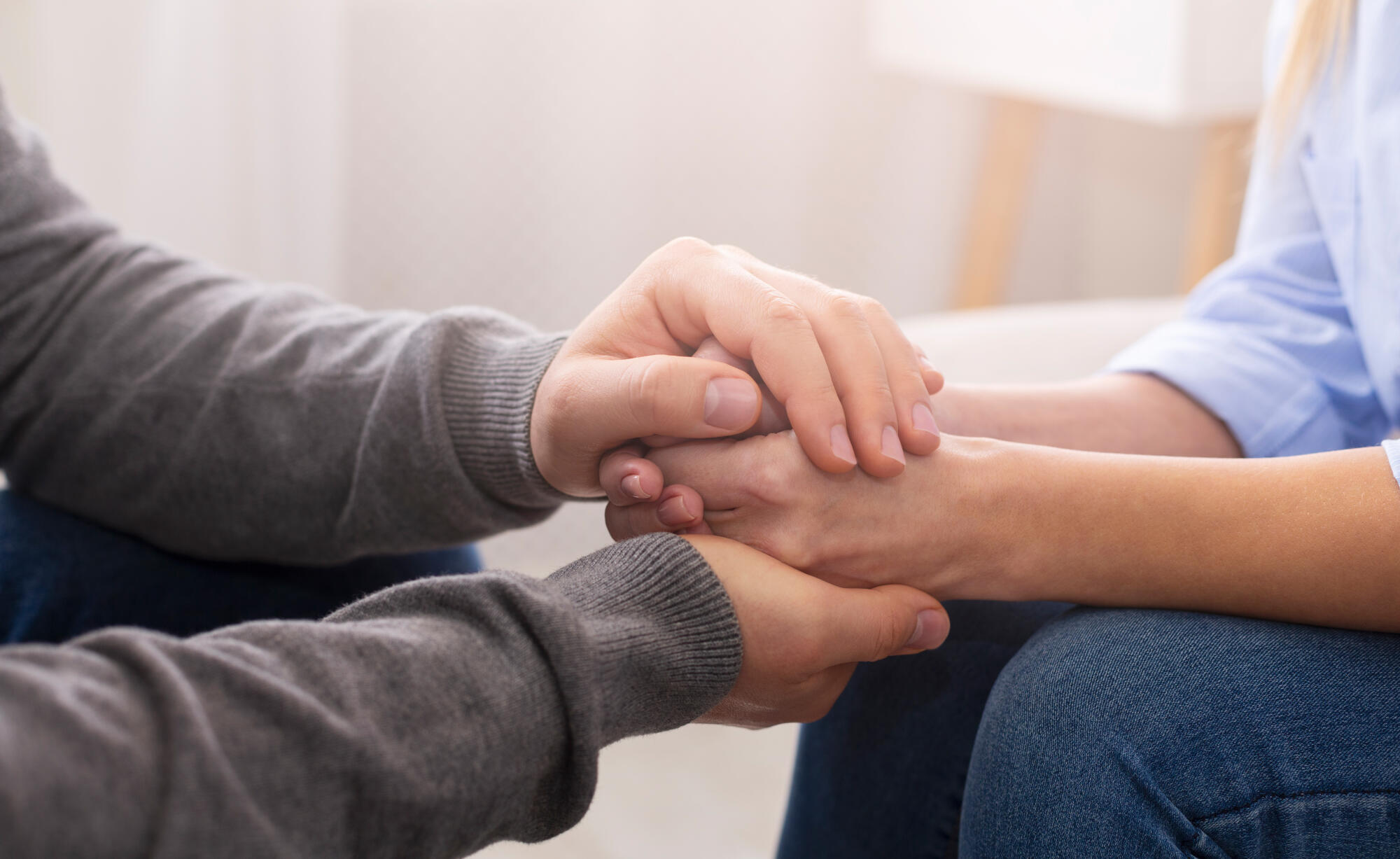Psychiatrist councelling his patient hands during therapy