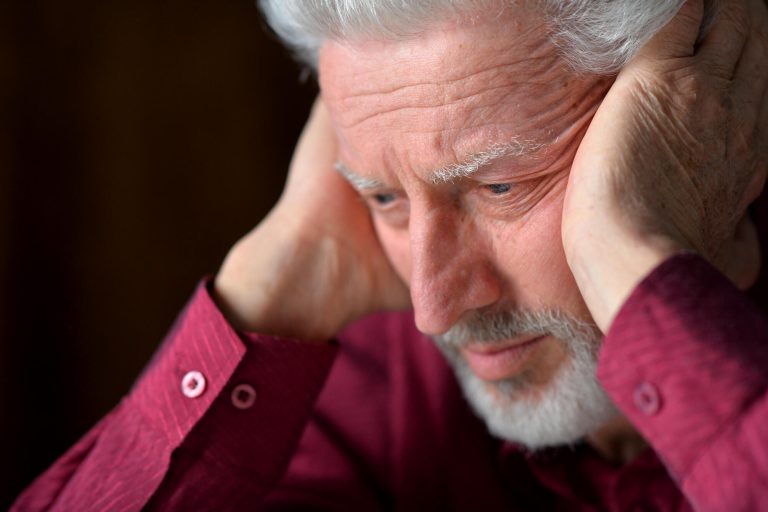 close up portrait of a senior man thinking about something