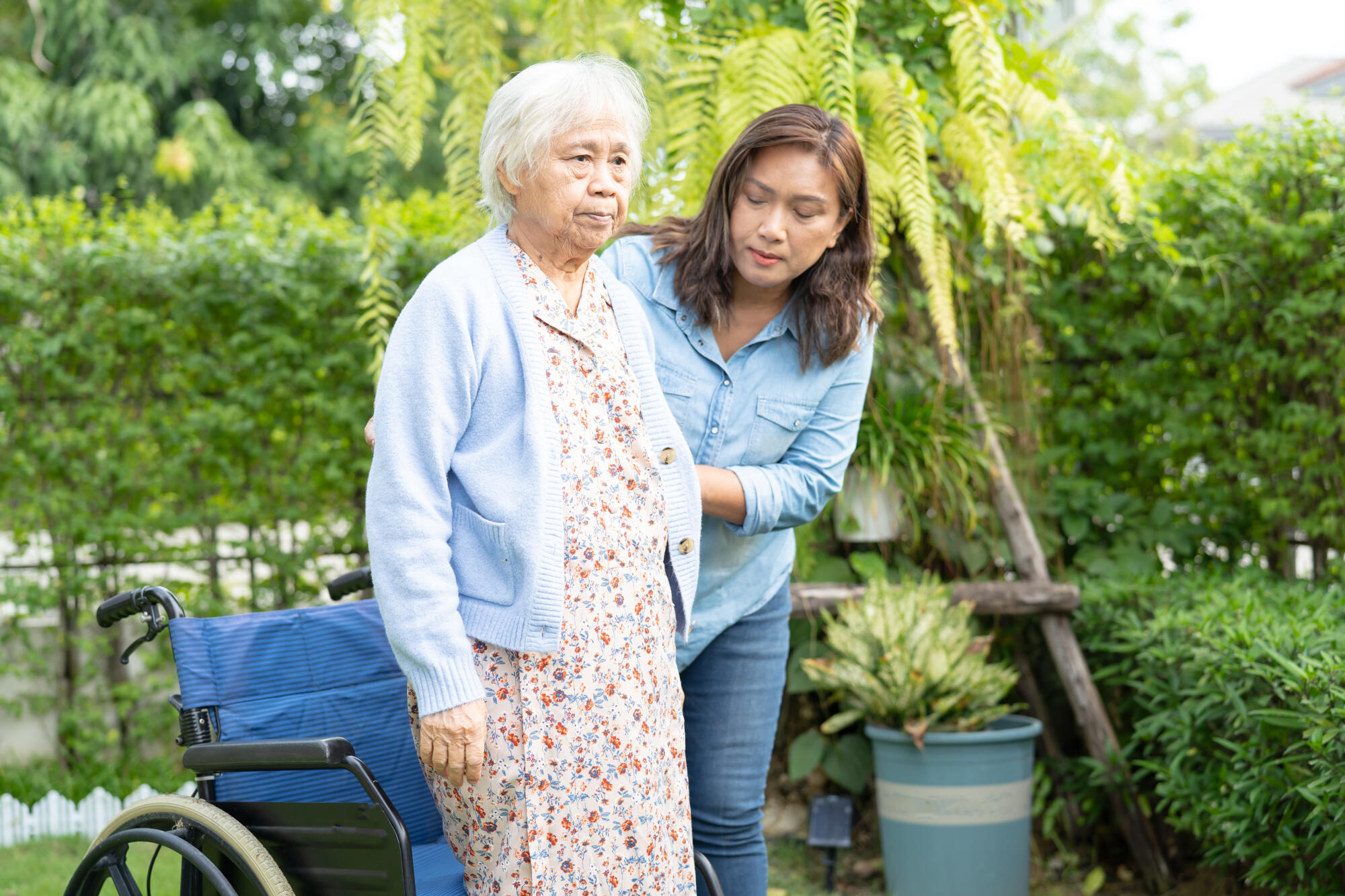 Caregiver help and care Asian senior woman patient sitting on wh