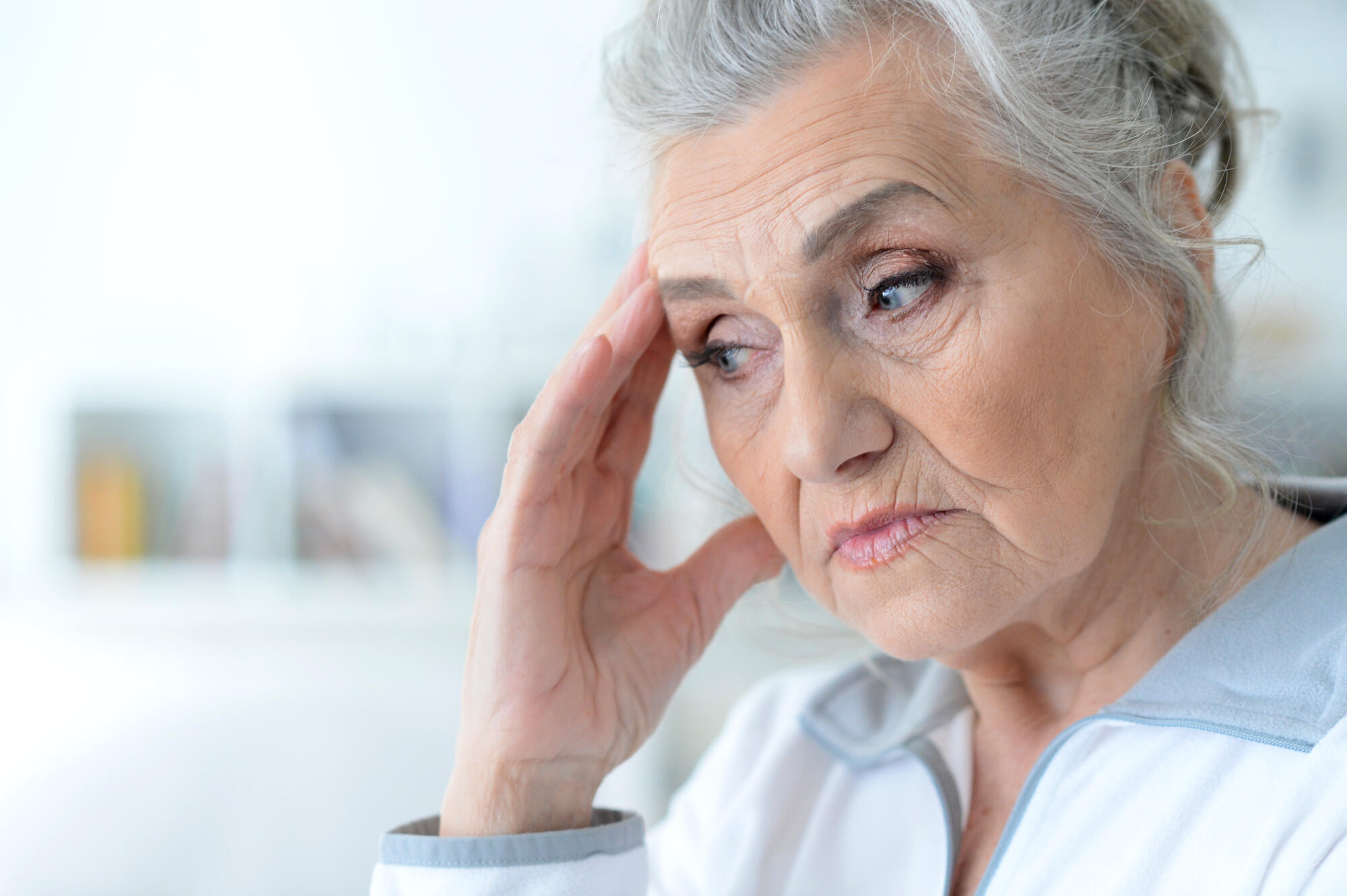 Portrait of a sad elderly woman posing at home