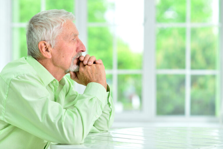 close up portrait of a senior man thinking about something
