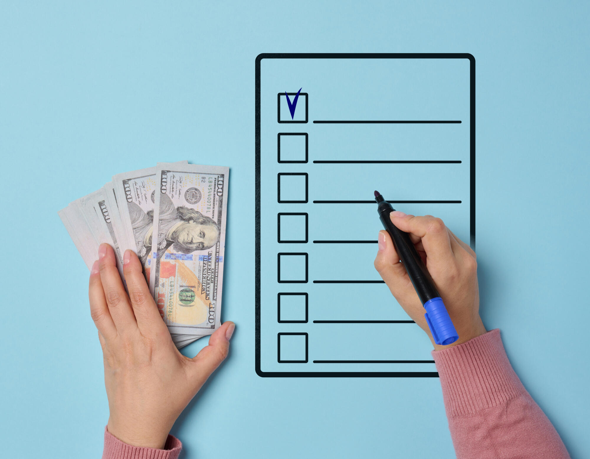 A woman’s hand holding a stack of American dollars and filling o A woman's hand holding a stack of American dollars and filling o