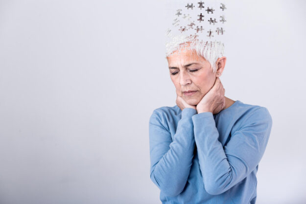 Memory loss due to dementia. Senior woman losing parts of head as symbol of decreased mind function. Senior woman losing parts of head feeling confused as symbol of decreased mind function. Memory loss due to dementia. Senior woman losing parts of head as symbol of decreased mind function. Senior woman losing parts of head feeling confused as symbol of decreased mind function.