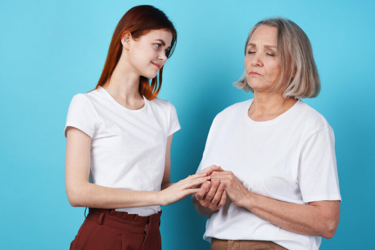 Mom and daughter hold hands in white t shirts family together