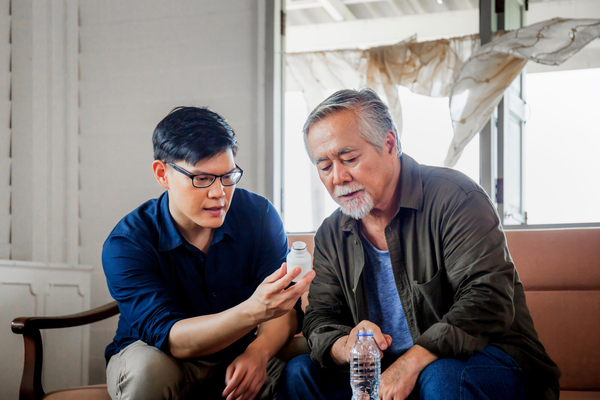 Middle aged son takes care of sick senior father, Happiness Asia