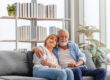 Elderly woman and a man relaxing on cozy sofa at home, Happy sen