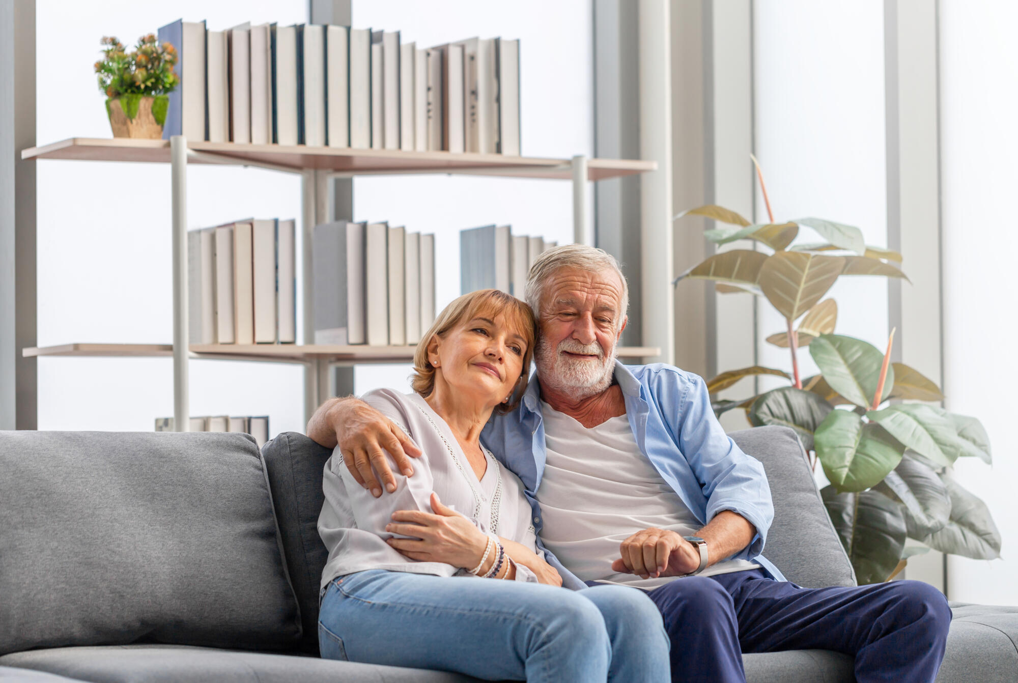 Elderly woman and a man relaxing on cozy sofa at home, Happy sen