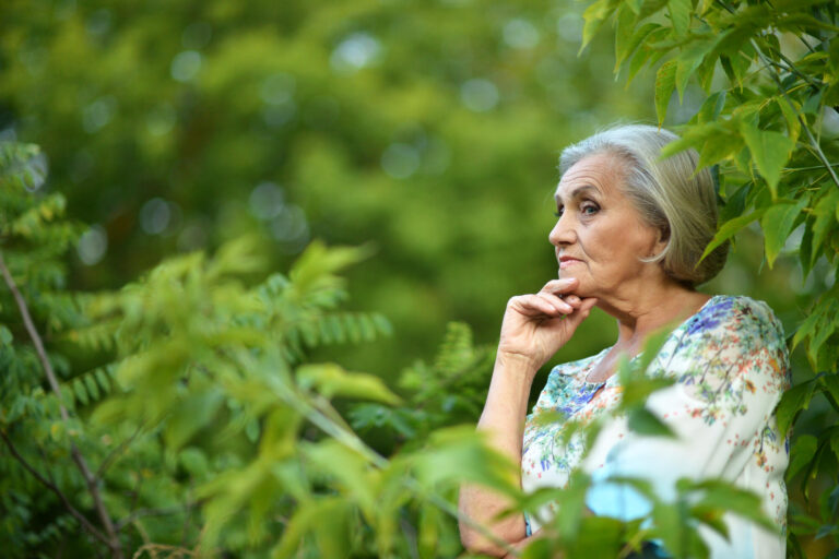 Portrait of senior woman in summer park