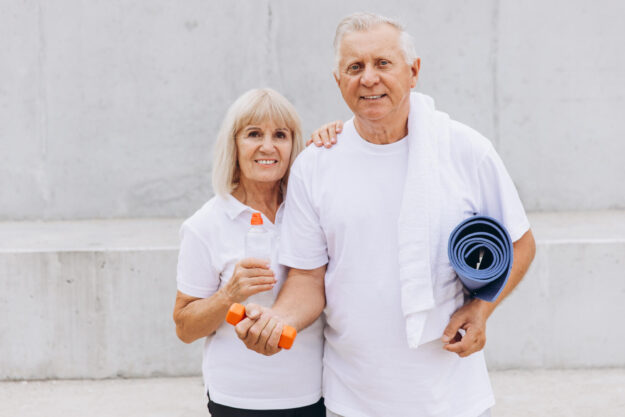 Senior Couple Enjoying Fitness Together with Dumbbells and Yoga Mat Outdoors Senior Couple Enjoying Fitness Together with Dumbbells and Yoga Mat Outdoors