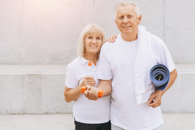 Senior Couple Enjoying Fitness Together with Dumbbells and Yoga Senior Couple Enjoying Fitness Together with Dumbbells and Yoga