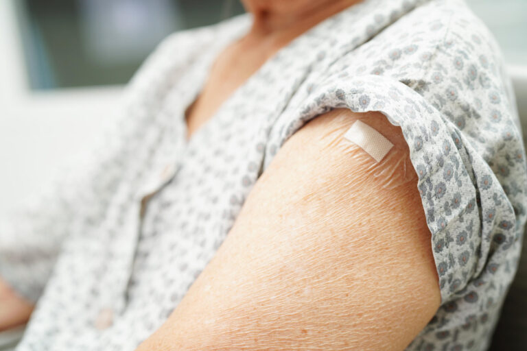 Asian elder senior woman getting vaccine for protect corona viru