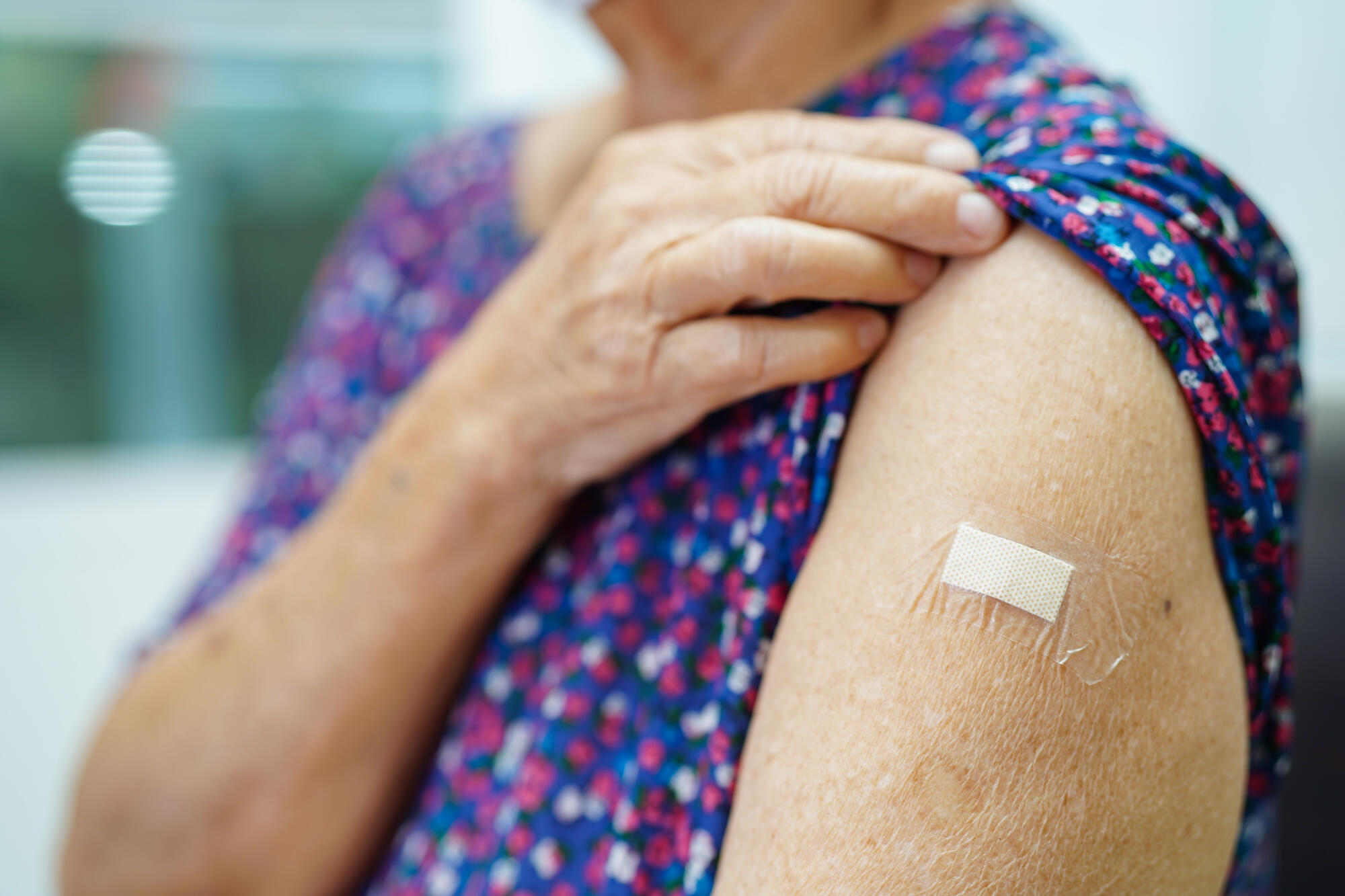 Asian elder senior woman getting vaccine for protect corona viru