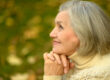 Portrait of senior woman walking in autumn park