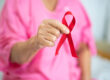 Breast cancer, pink ribbon at Asian senior lady patient for supp