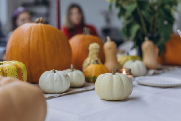 Children and adults painting pumpkins for Halloween, enjoying a fun and creative activity together. Children and adults painting pumpkins for Halloween, enjoying a fun and creative activity together.