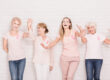 Four,Women,In,Pink,T shirts,Are,Laughing,And,Holding,Hands.