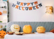 Pumpkin carving and festive garland on the wall preparing Halloween decorations at home