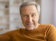 Senior gentleman smiling with bright background