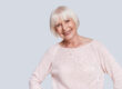 Beauty has no age. Beautiful senior woman looking at camera and smiling while standing against grey background